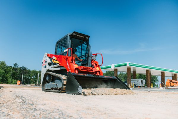 Takeuchi TL11R3 compact track loader with radial lift boom, enclosed cab, touchscreen display, and heavy-duty design for grading and dirt work